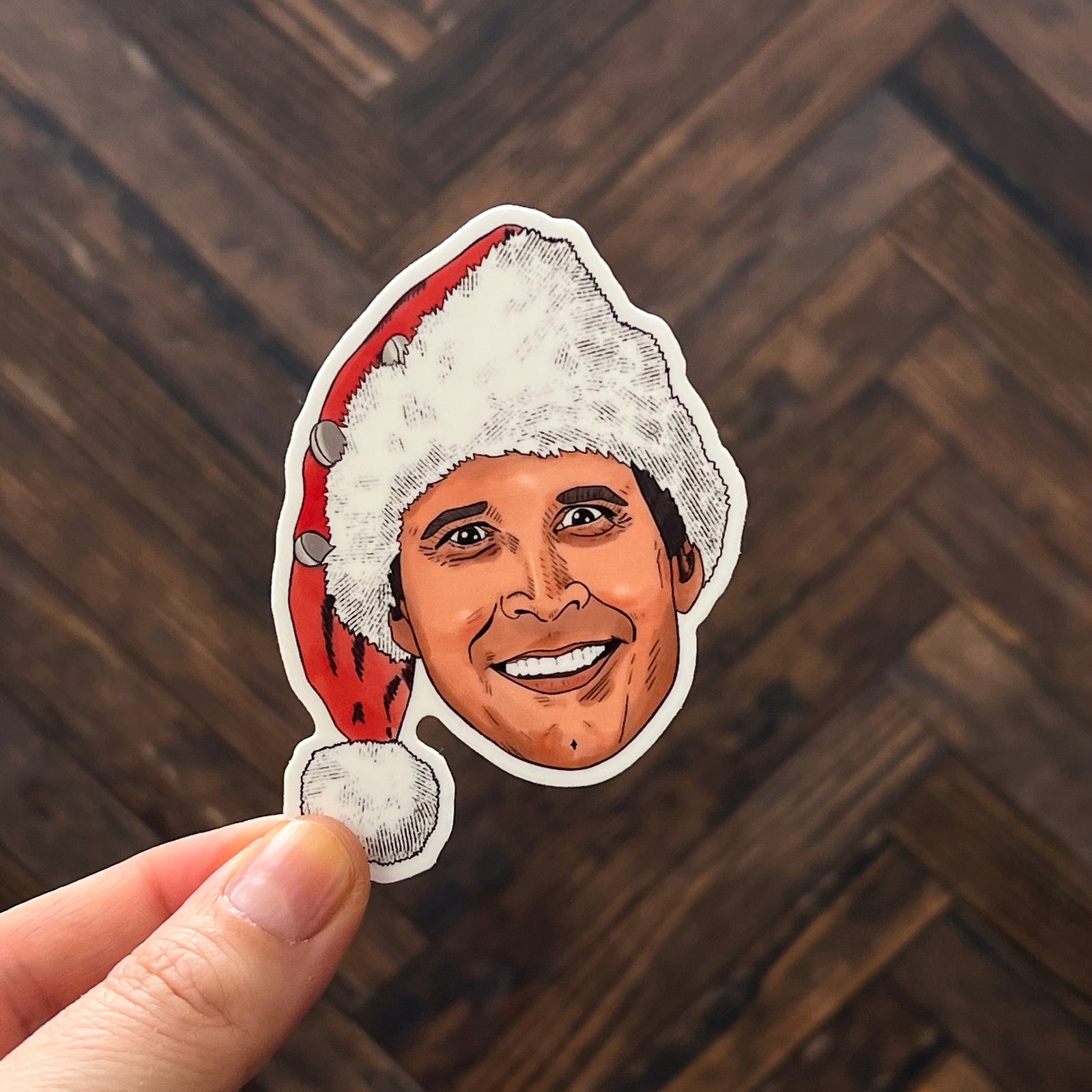 An illustrated portrait sticker of Chevy Chase in National Lampoon's Christmas Vacation, which was a weird movie to watch right before midnight mass year after year, right?