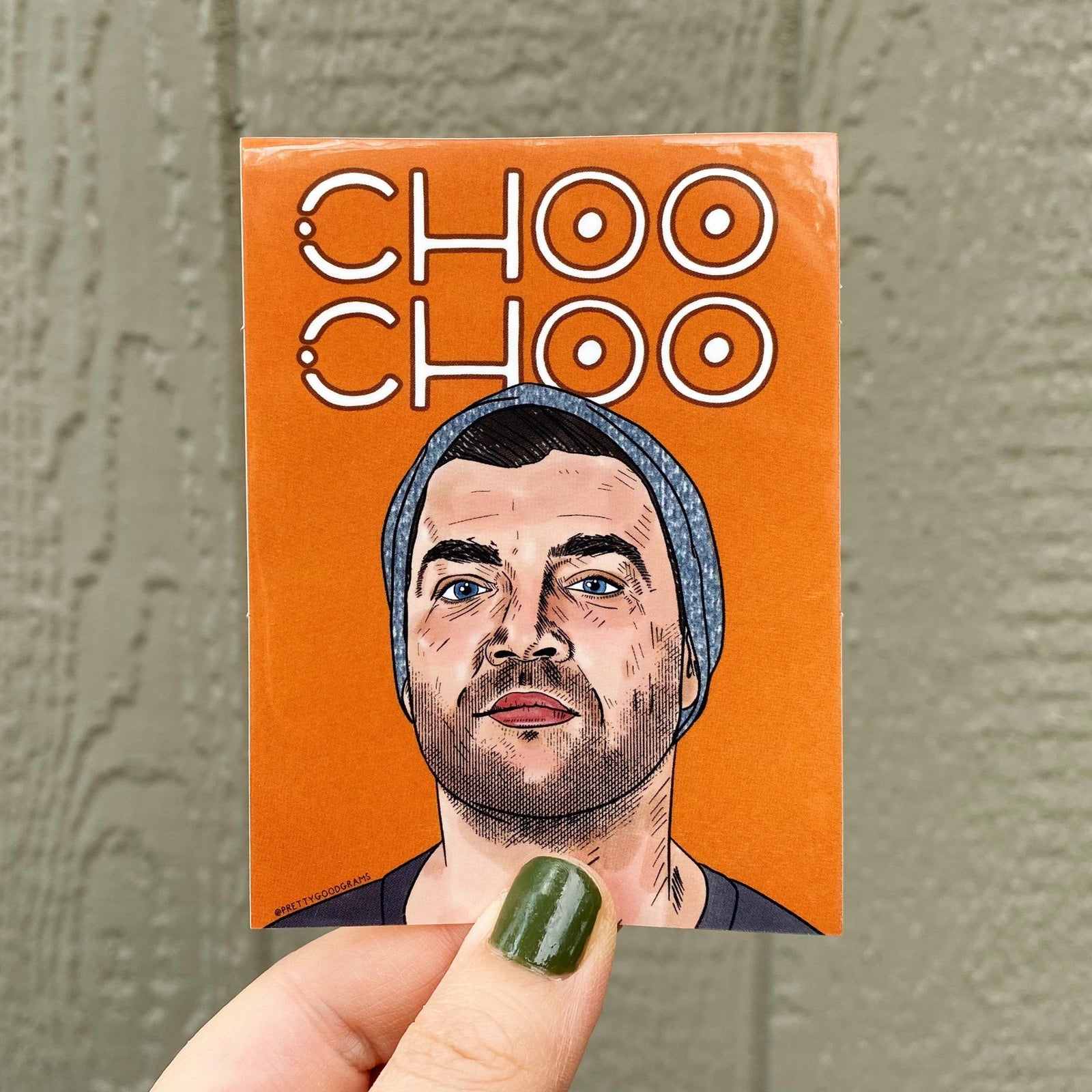 An illustrated sticker featuring a portrait of Chris CT Tamburello from The Traitors and The Challenge. The  text reads CHOO CHOO. The background is orange.