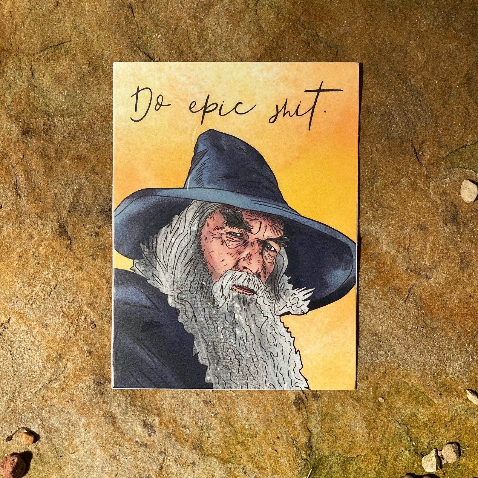 An illustrated sticker featuring Gandalf the Grey and the text "Do epic shit"