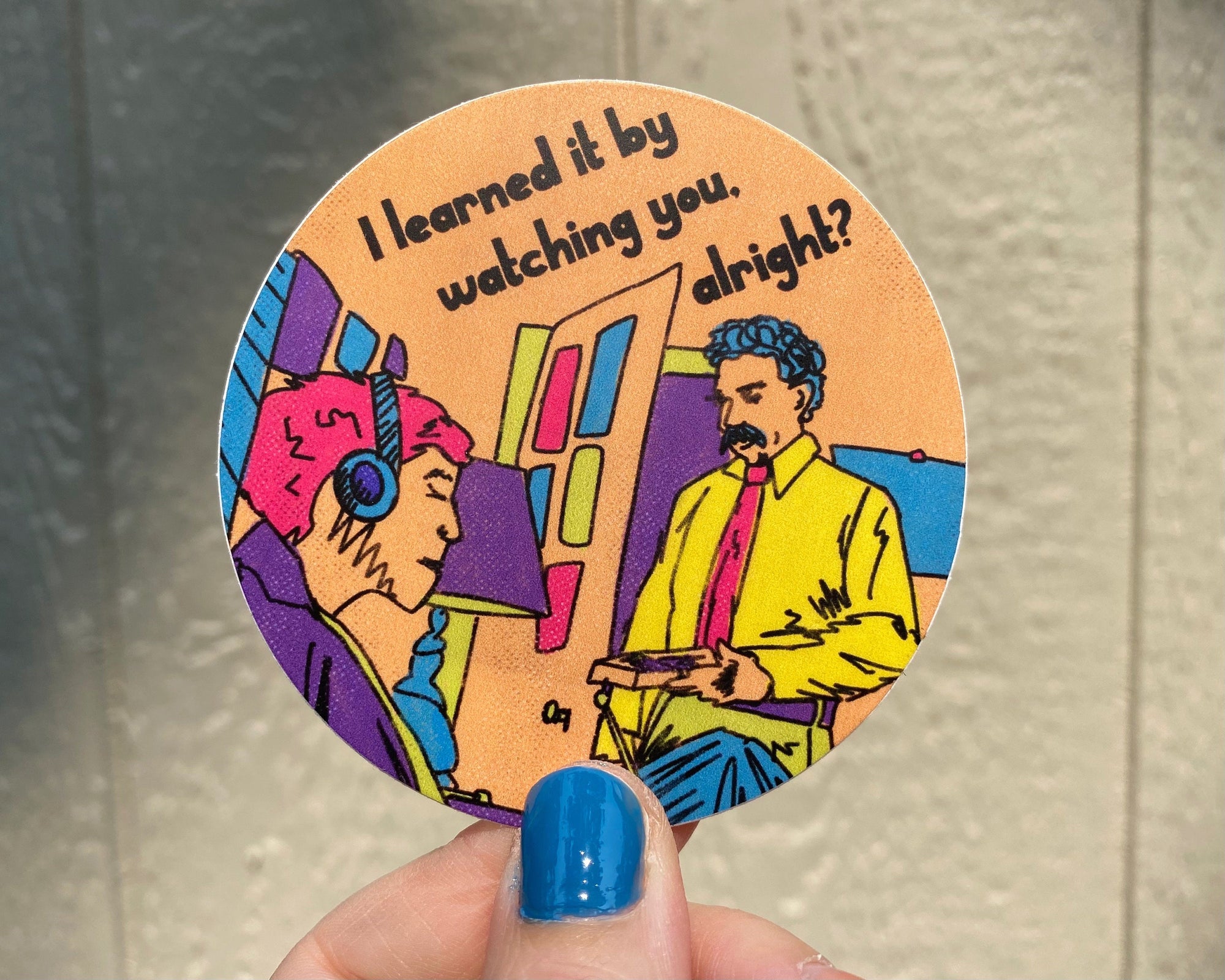 A round sticker with an illustration of the "I learned it by watching you, alright? commercial